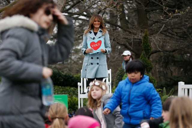 Children and U.S. first lady Melania Trump stand up after she read Sandra Boynton's book "You!" to children gathered for the annual White House Easter Egg Roll on the South Lawn of the White House in Washington, U.S., April 2, 2018. REUTERS/Leah Millis