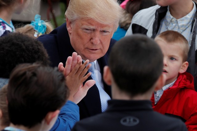 U.S. President Donald Trump greets children during the annual White House Easter Egg Roll on the South Lawn of the White House in Washington, U.S., April 2, 2018. REUTERS/Carlos Barria