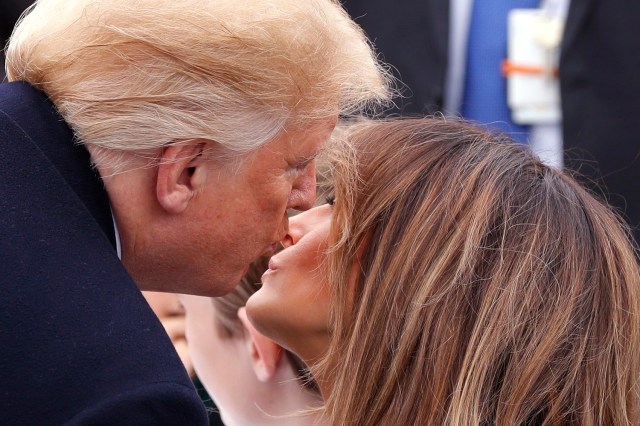 U.S. President Donald Trump kisses first lady Melania Trump during the annual White House Easter Egg Roll on the South Lawn of the White House in Washington, U.S., April 2, 2018. REUTERS/Carlos Barria