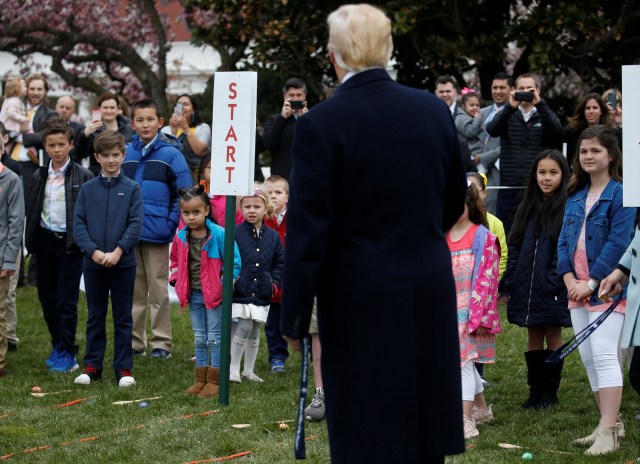 U.S. President Donald Trump greets children before blowing the whistle for their egg roll during the annual White House Easter Egg Roll on the South Lawn of the White House in Washington, April 2, 2018. REUTERS/Leah Millis