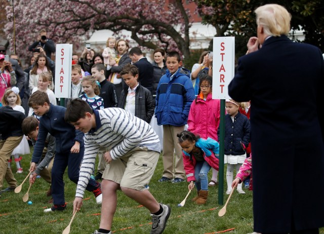 U.S. President Donald Trump blows the whistle to start an egg roll during the annual White House Easter Egg Roll on the South Lawn of the White House in Washington, April 2, 2018. REUTERS/Leah Millis