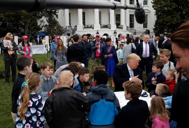 U.S. President Donald Trump greets children after they made drawings for U.S. military members during the annual White House Easter Egg Roll on the South Lawn of the White House in Washington, April 2, 2018. REUTERS/Leah Millis