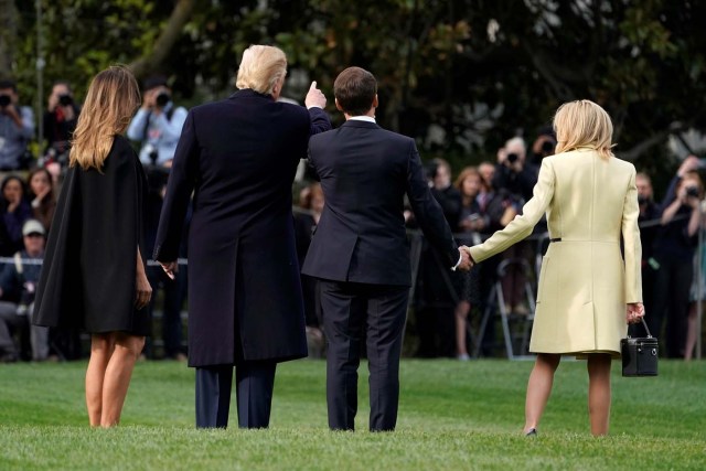U.S. President Donald Trump and first lady Melania Trump walk with French President Emmanuel Macron and his wife Brigitte Macron after planting a tree on the South Lawn of the White House in Washington,. U.S., April 23, 2018. REUTERS/Joshua Roberts