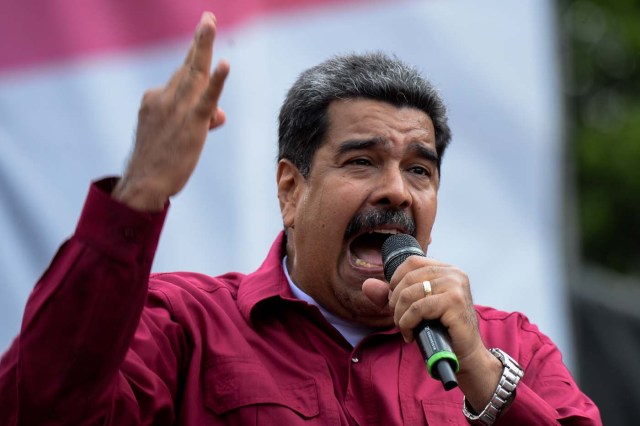 Venezuelan President Nicolas Maduro delivers a speech during a May Day rally in Caracas, on May 1, 2018.   / AFP PHOTO / Federico PARRA