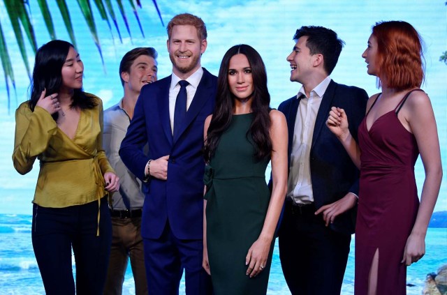 Models pose with waxwork representations of Britain's Prince Harry and his fiancee Meghan Markle, seen on display at Madame Tussauds in London, Britain, May 9, 2018. REUTERS/Toby Melville