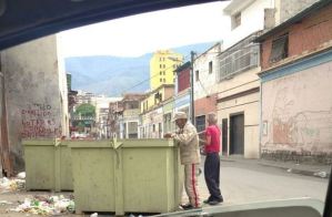 ¿Venezuela Victoriosa? Un miliciano resuelve la papa del día revolviendo la basura (FOTO)